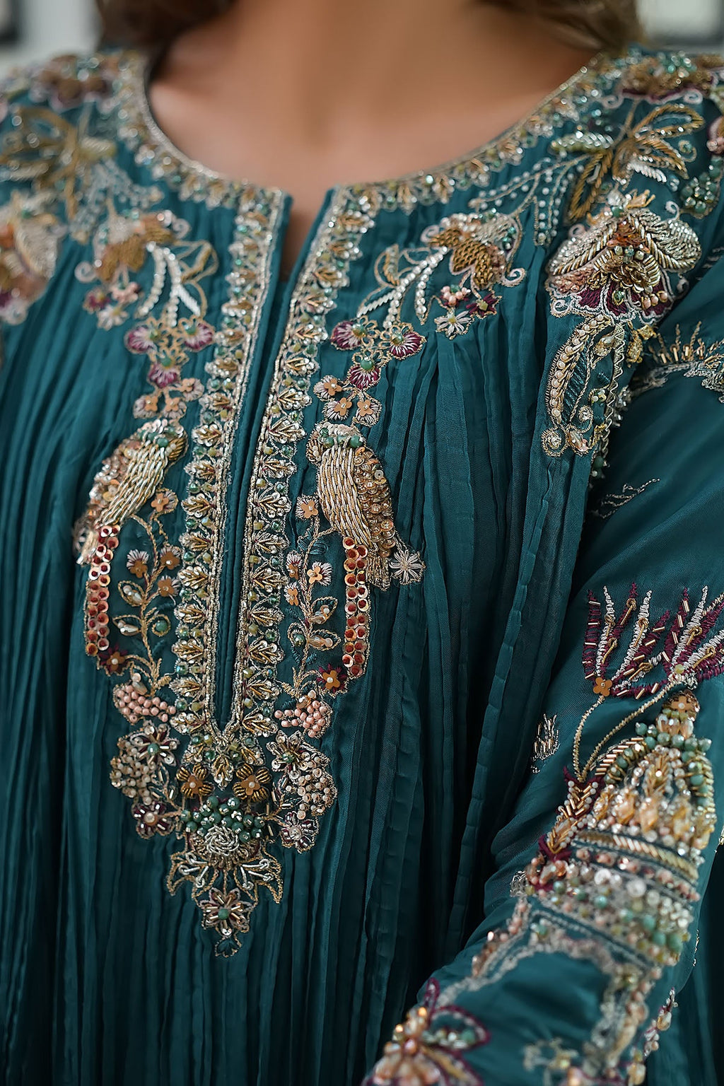 "Close-up detailing on Motifz 0079 Mahnoor stitched silk suit, displaying intricate hand-embellished neckline work, zardozi accents, and delicate embroidery."