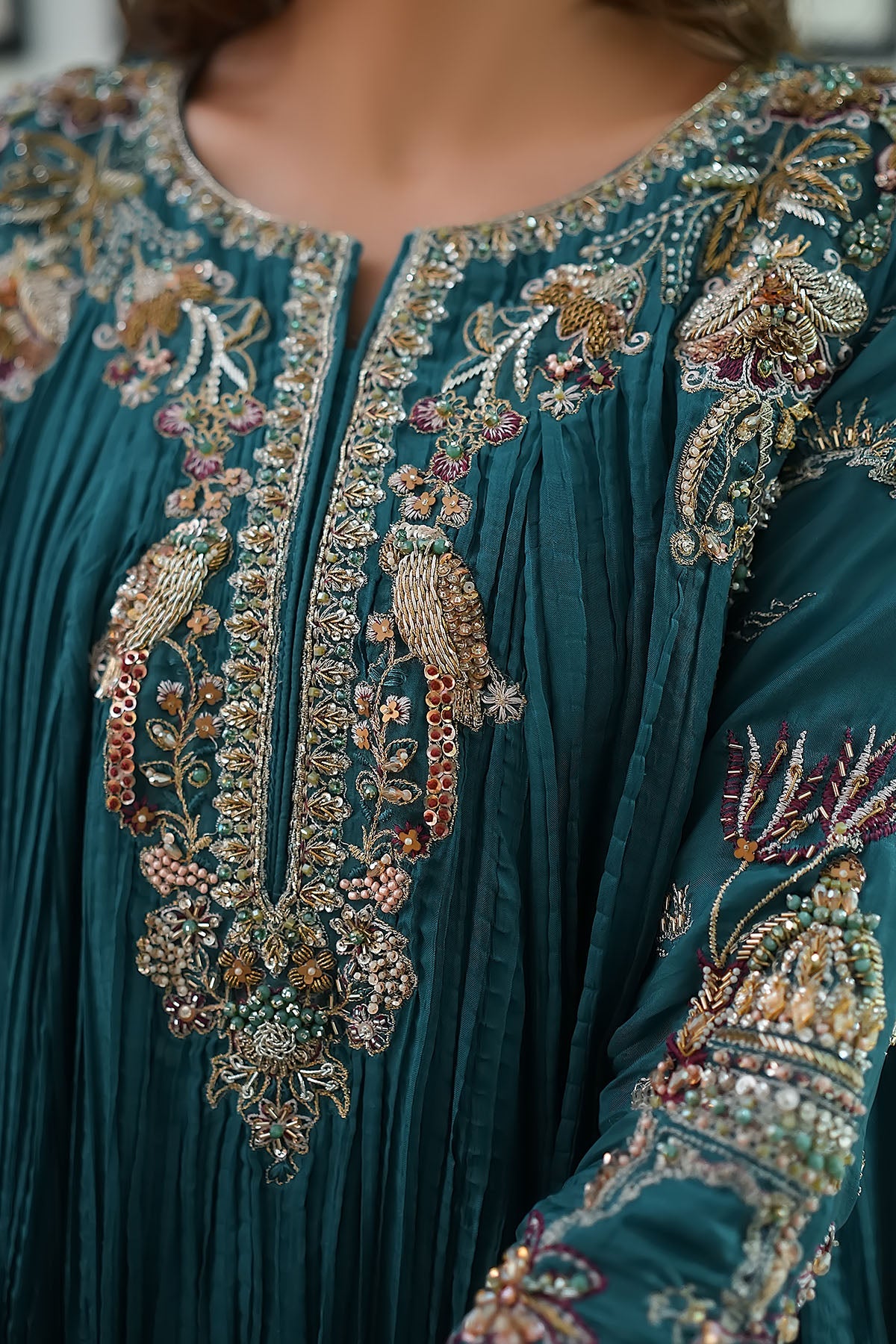 "Close-up detailing on Motifz 0079 Mahnoor stitched silk suit, displaying intricate hand-embellished neckline work, zardozi accents, and delicate embroidery."