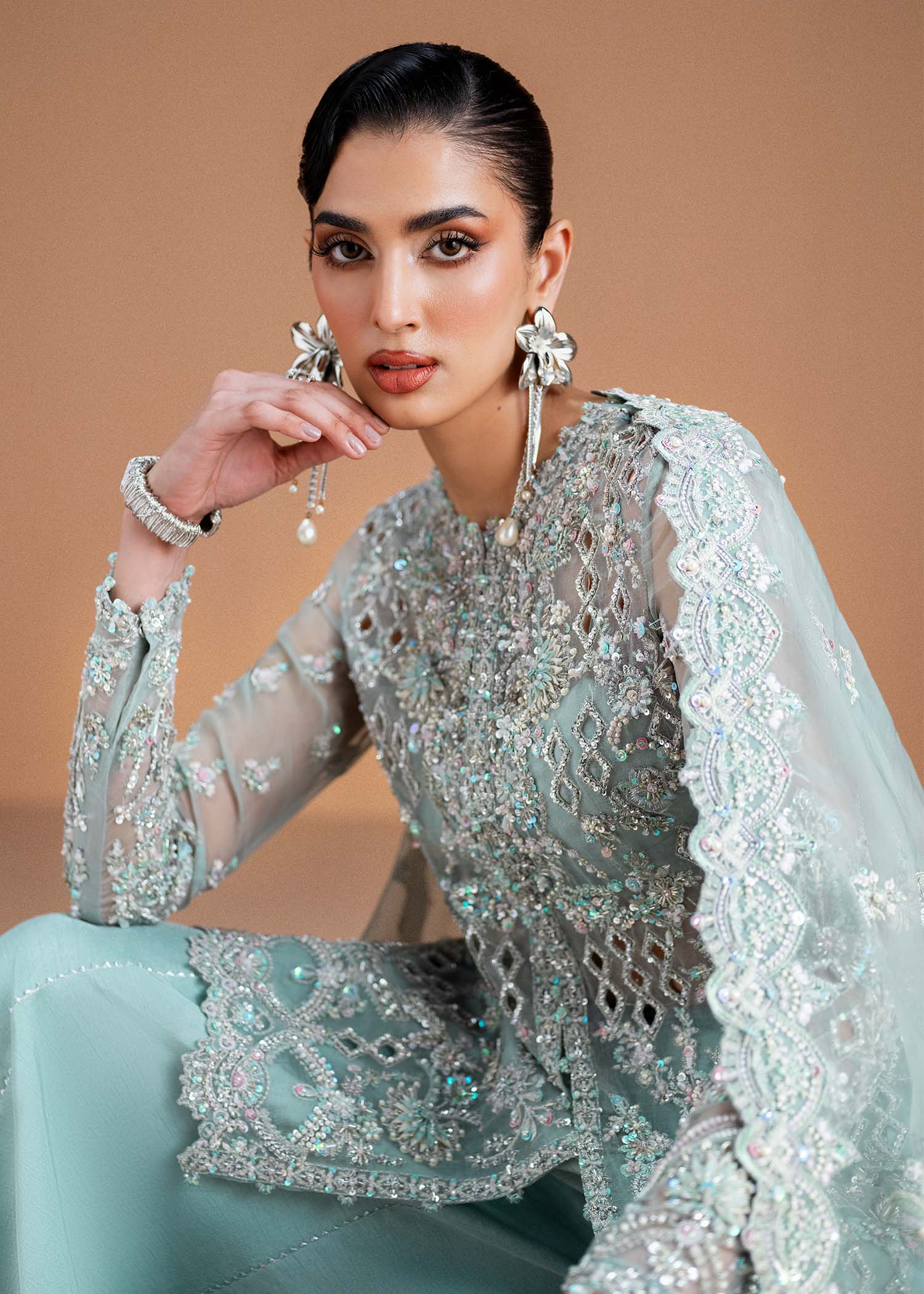 "Detailed frame highlighting the fully embellished sparkling organza dupatta from the Kanwal Malik Vania collection, neatly draped alongside the crisp bottom flare of the premium Korean raw silk trousers."