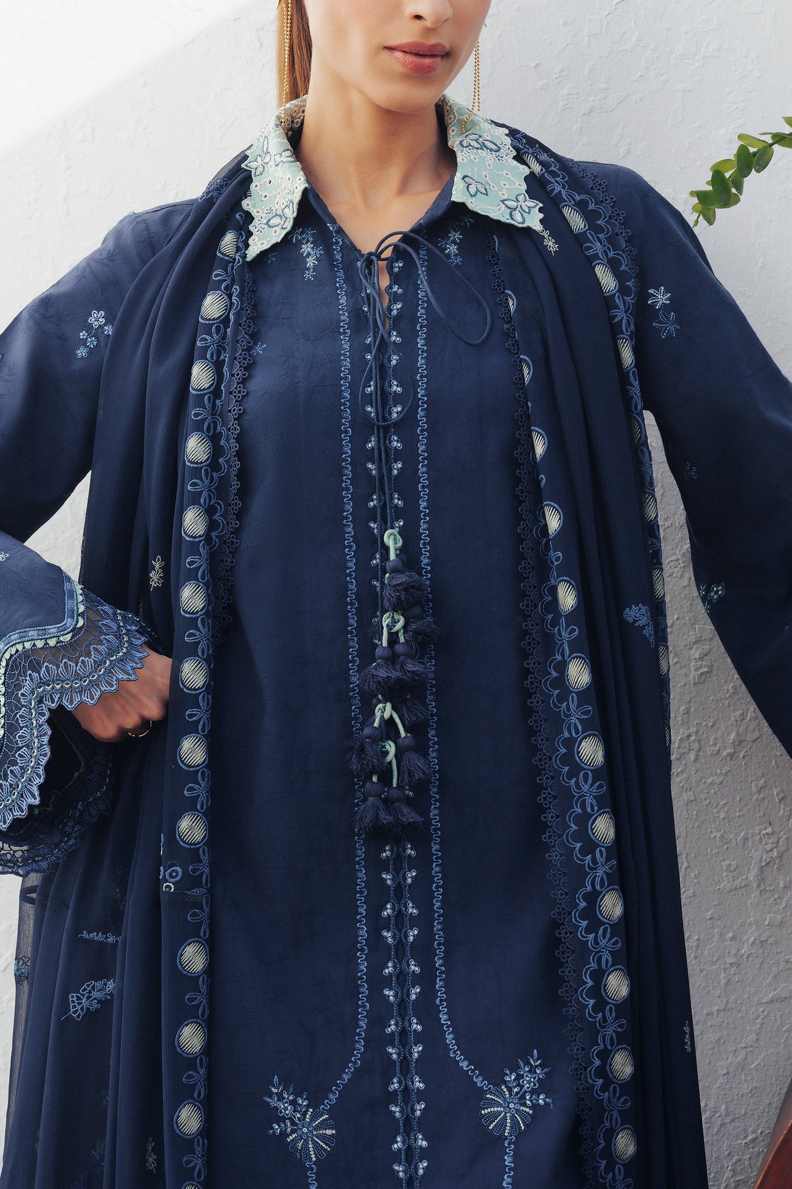 "Close-up detailing on the Qalamkar QBP-02 DARIA shirt bodice, displaying fine threadwork embroidery, embellished neck finishes, and soft fabric texture."