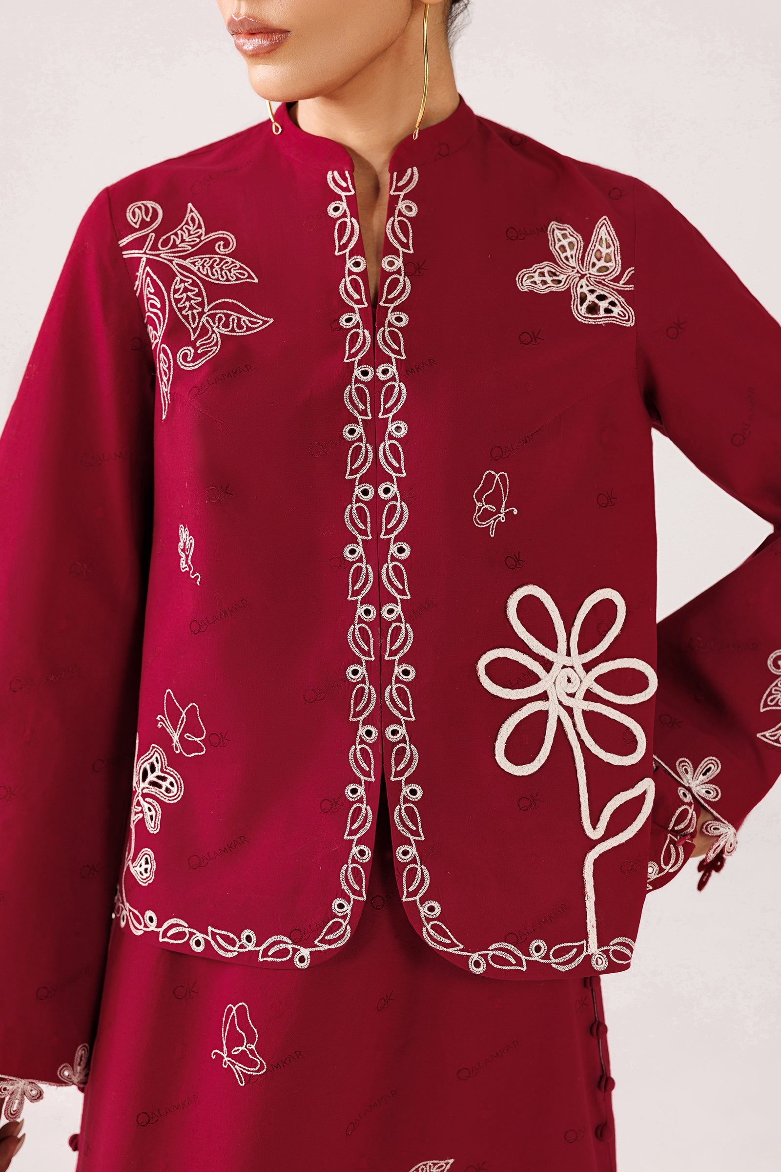 "Close-up detailing on the Qalamkar QEC-10 Reina shirt bodice, displaying oversized floral motifs, contrast ivory threadwork, and rich textured self-jacquard fabric."