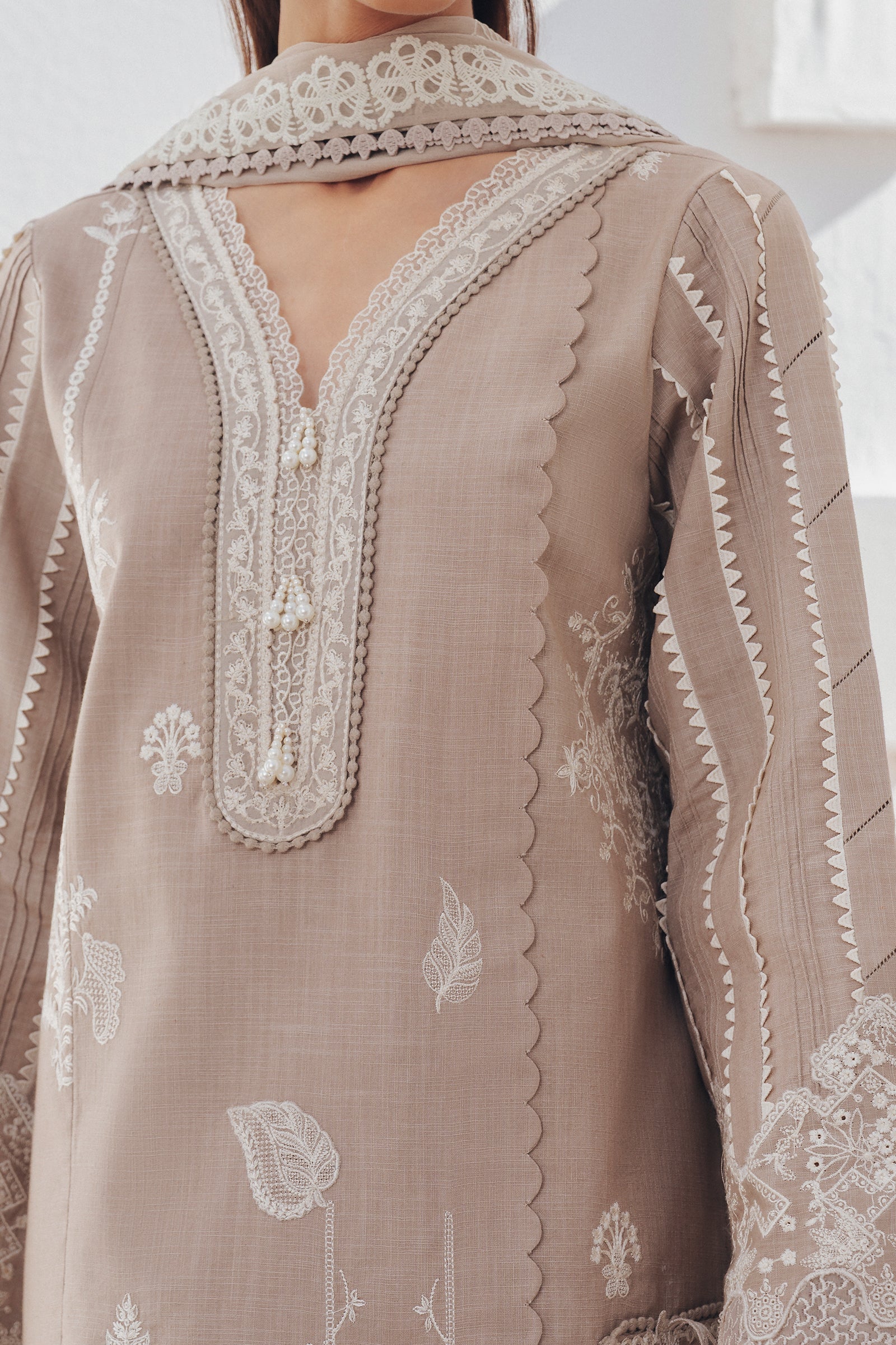 "Close-up detailing on the Qalamkar QBP-08 ELKE shirt bodice, displaying fine threadwork embroidery, embellished neck finishes, and soft fabric texture."