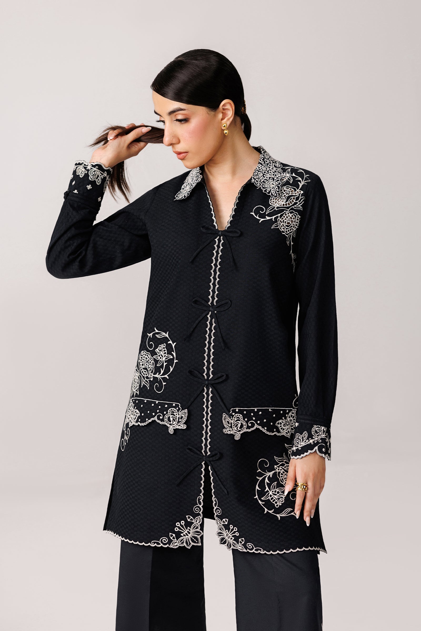"Close-up detailing on the Qalamkar QEC-02 Ana shirt bodice, displaying fine threadwork embroidery, embellished neck finishes, and soft fabric texture."
