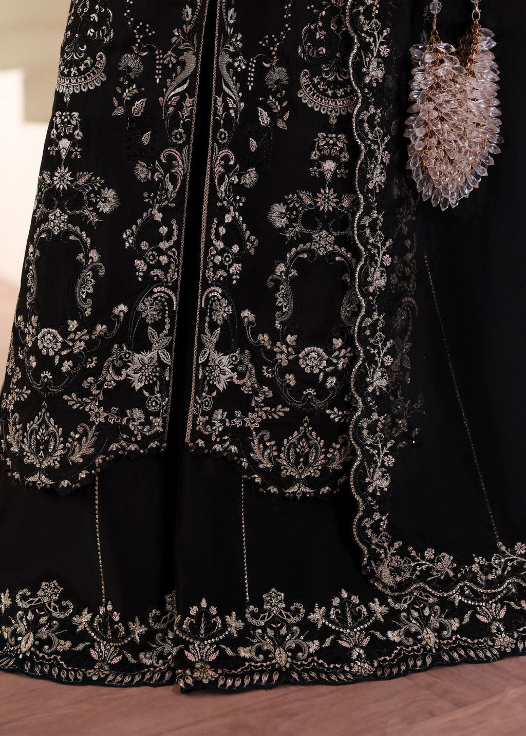 "Close-up profile of the sleeves and lower trouser hem from the Kanwal Malik Mahsa ensemble, focusing on the sharp contemporary stitching, rich raw silk fabric weight, and matching border trims."