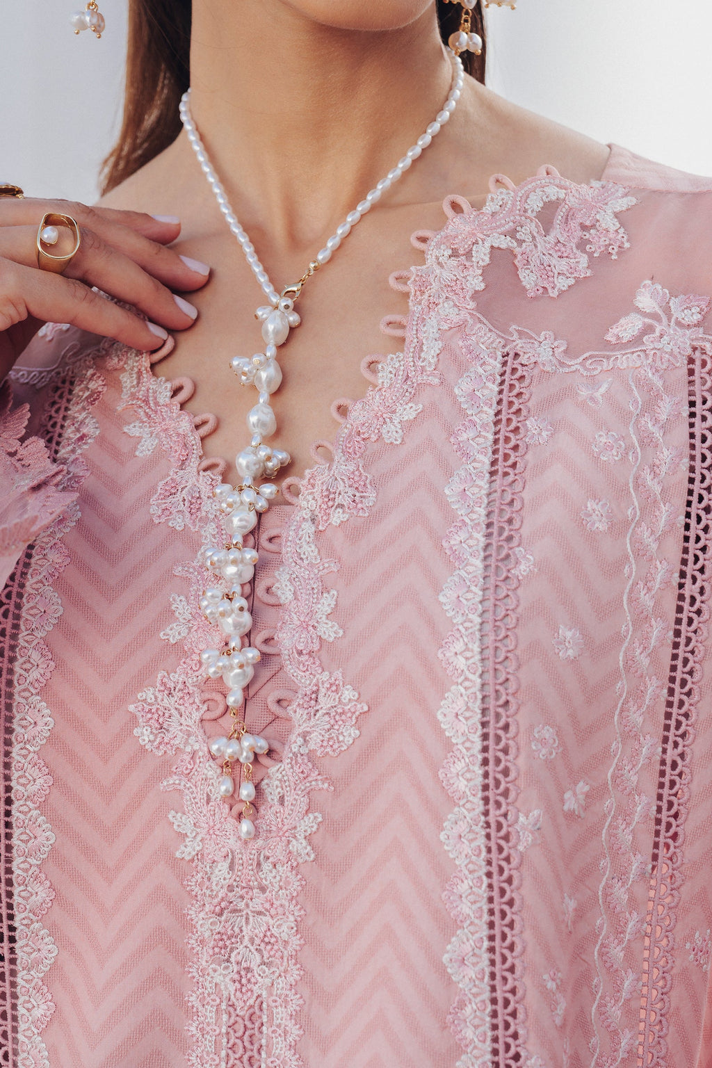 "Close-up detailing on the Qalamkar QBP-03 GIANA shirt bodice, displaying fine threadwork embroidery, embellished neck finishes, and soft fabric texture."
