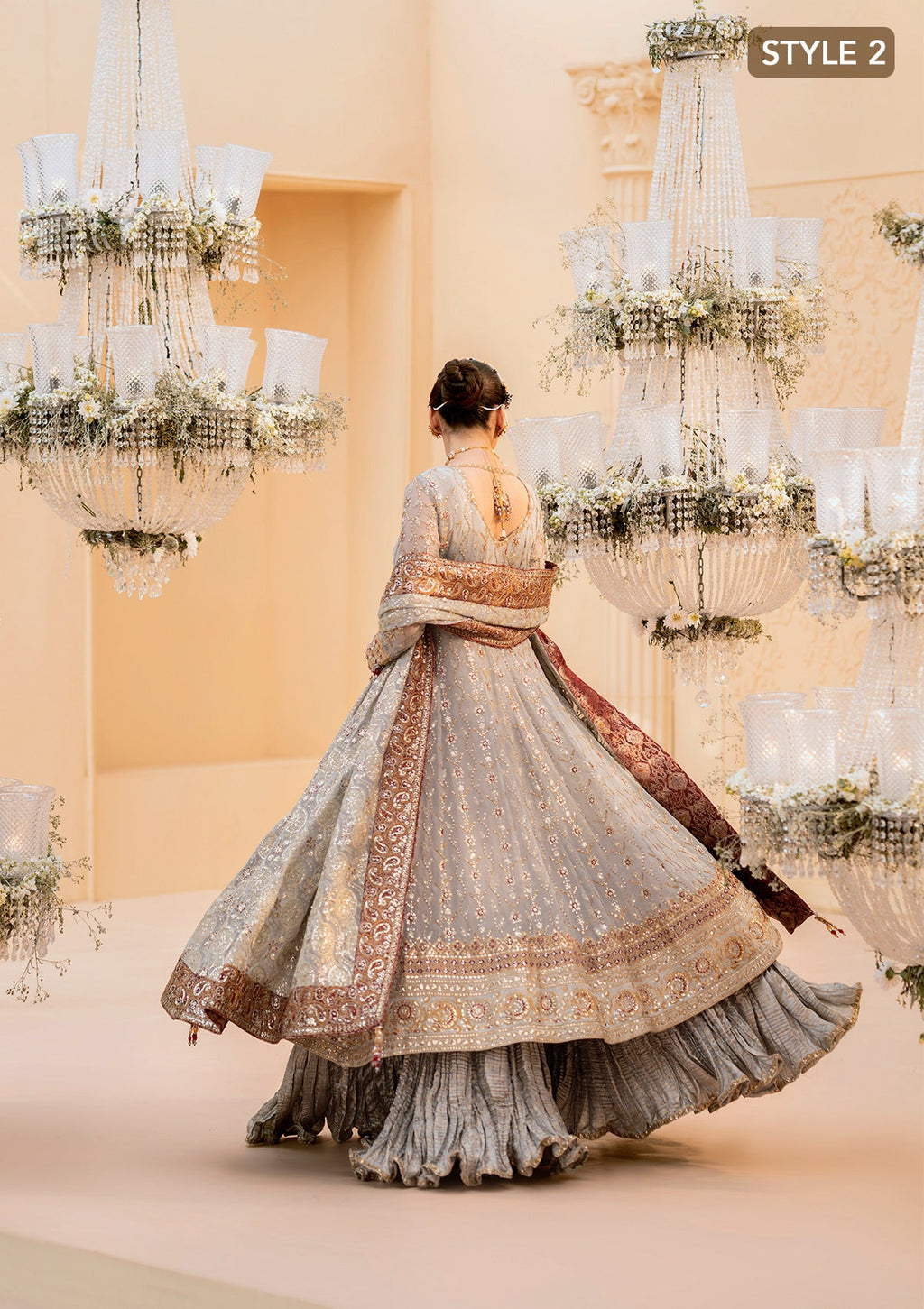 "Lower frame and sleeve profile view of the Aik Wedding Festive Look A2502 ensemble, focusing on the multi-layered embroidered organza patches, clean structural stitching, and elegant sleeve border finishes."