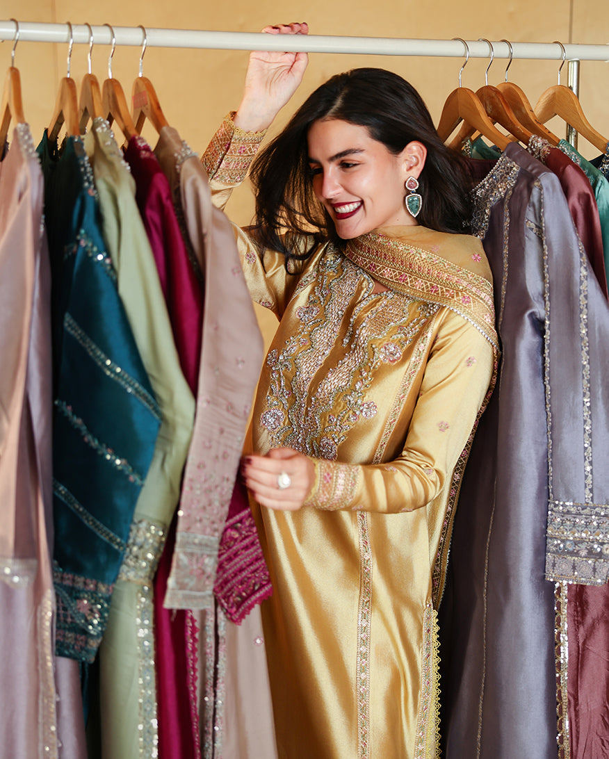 "Focus on the intricate sleeve cuff trimmings and lace hemline details of the Mushq Ezel stitched luxury suit, showing boutique-quality tailoring."