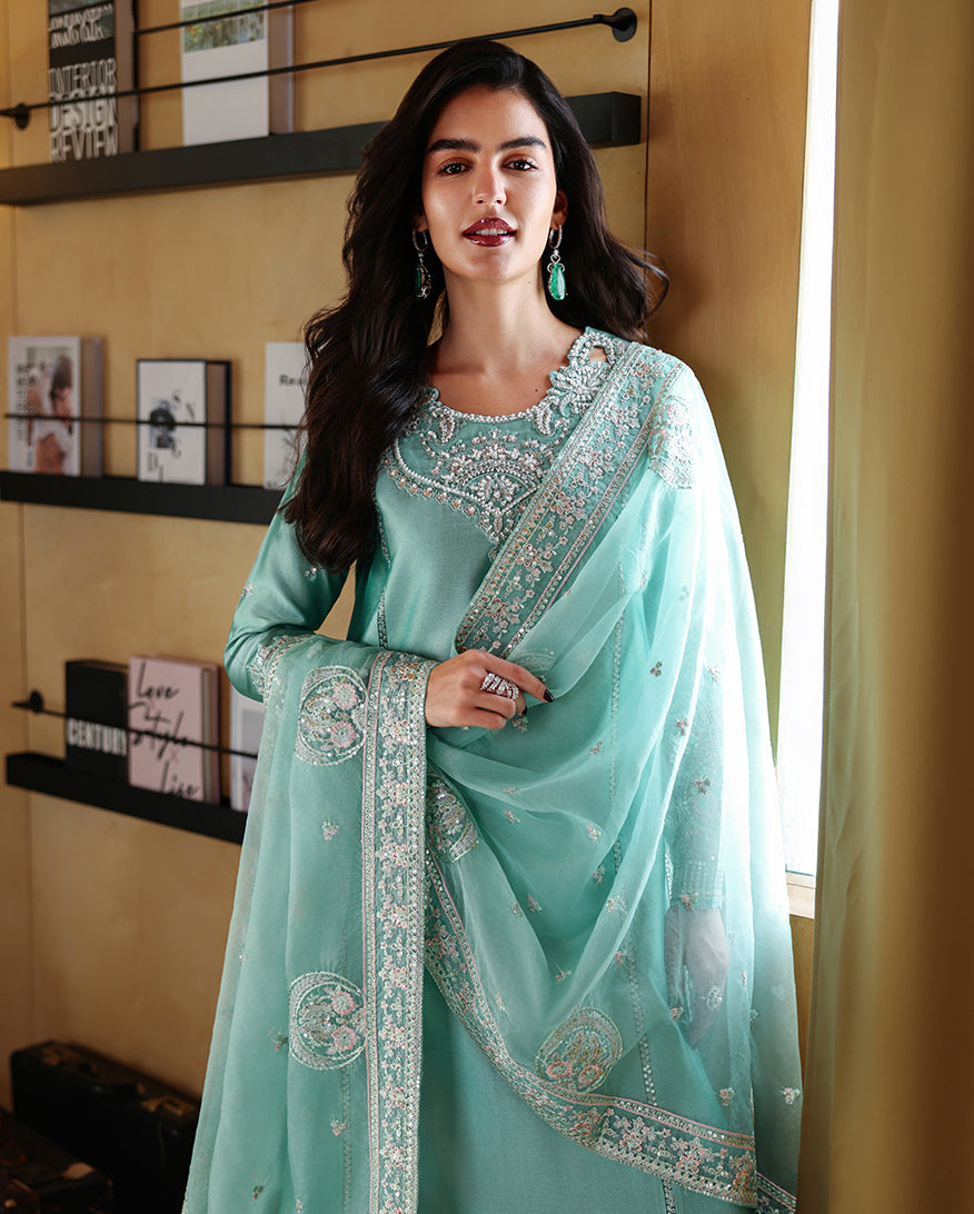 "Focus on the intricate sleeve cuff trimmings and lace hemline details of the Mushq Neyla stitched luxury suit, showing boutique-quality tailoring."
