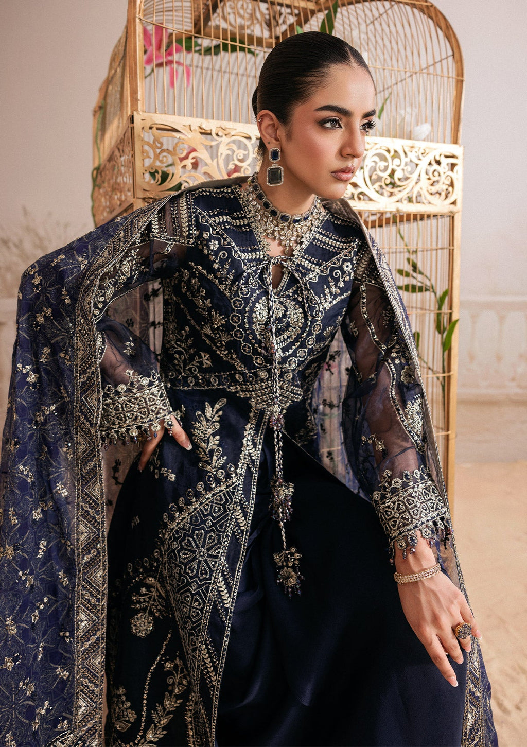 "Lower frame and sleeve focus of Aik Shaam Look B2604, emphasizing multi-textured embroidered patch borders, precise stitching lines, and tailored cuff finishes."