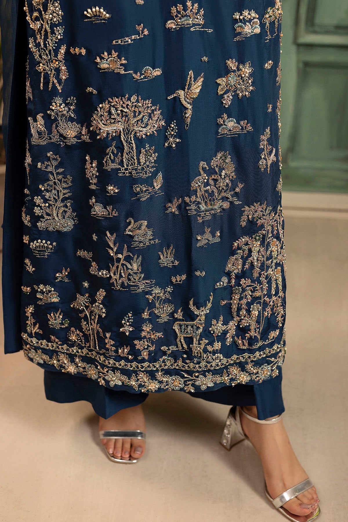 "Sleeve and hemline close-up of Motifz 0074 Afsana hand embellished silk ensemble, showcasing multi-layered organza patch borders and clean boutique stitching."