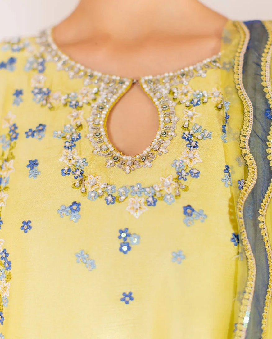 "Close-up detailing on the Mushq Lumiere shirt bodice, displaying fine threadwork embroidery, embellished neck finishes, and soft fabric texture."