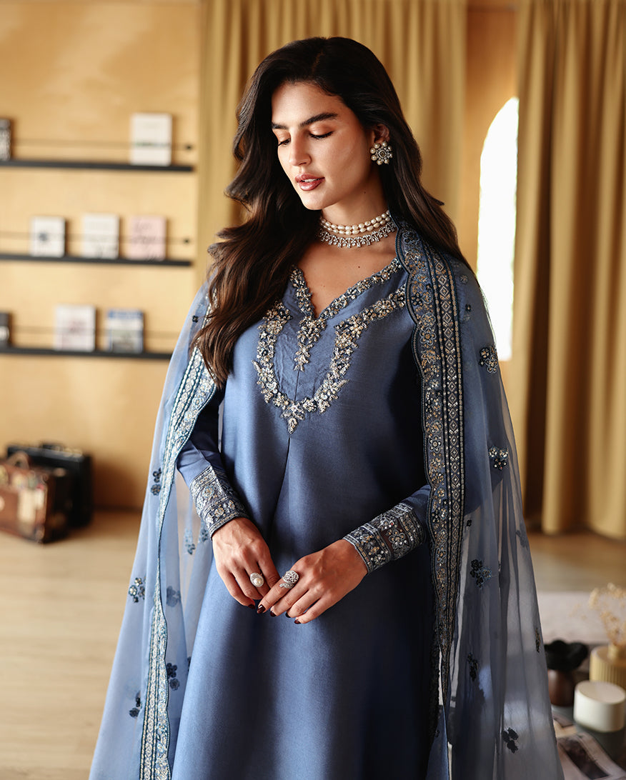 "Focus on the intricate sleeve cuff trimmings and lace hemline details of the Mushq Auren stitched luxury suit, showing boutique-quality tailoring."