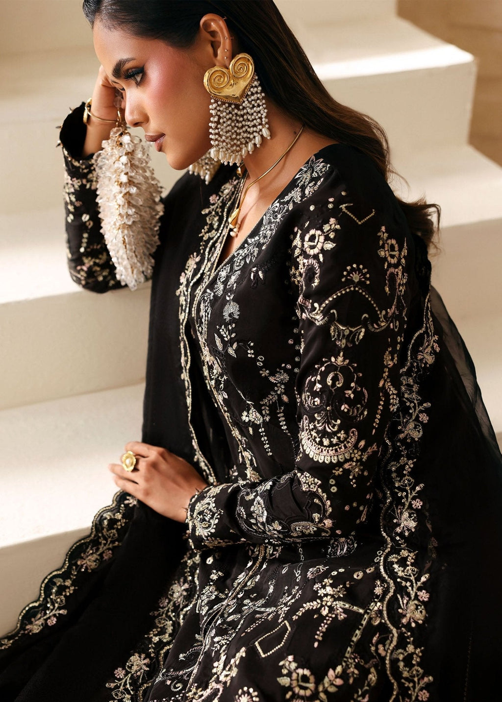 "Close-up premium craftsmanship on the Kanwal Malik Mahsa bottle green dress, showcasing detailed artisan handwork, fine traditional motifs, and gleaming embellishments on the neckline and front panels."