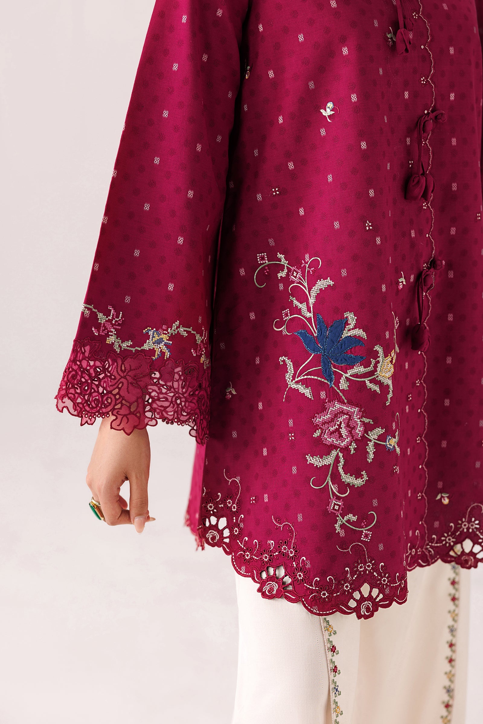 "Close-up detailing on the Qalamkar QEC-04 Alize shirt bodice, displaying fine threadwork embroidery, embellished neck finishes, and soft fabric texture."