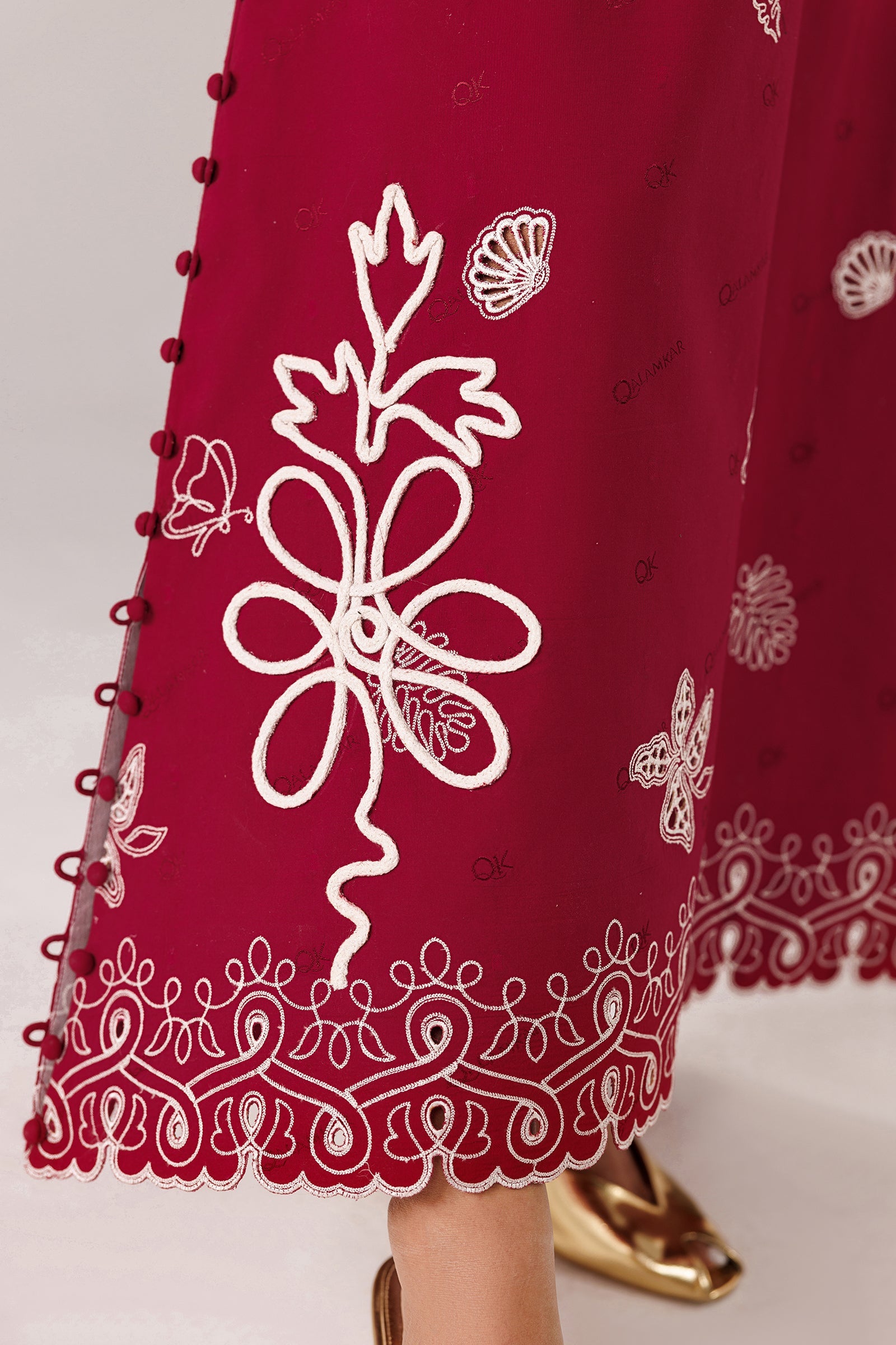 "Detailed drape view of the statement embroidered dupatta paired with the crimson Qalamkar QEC-10 Reina formal suit from Mirha Collections."