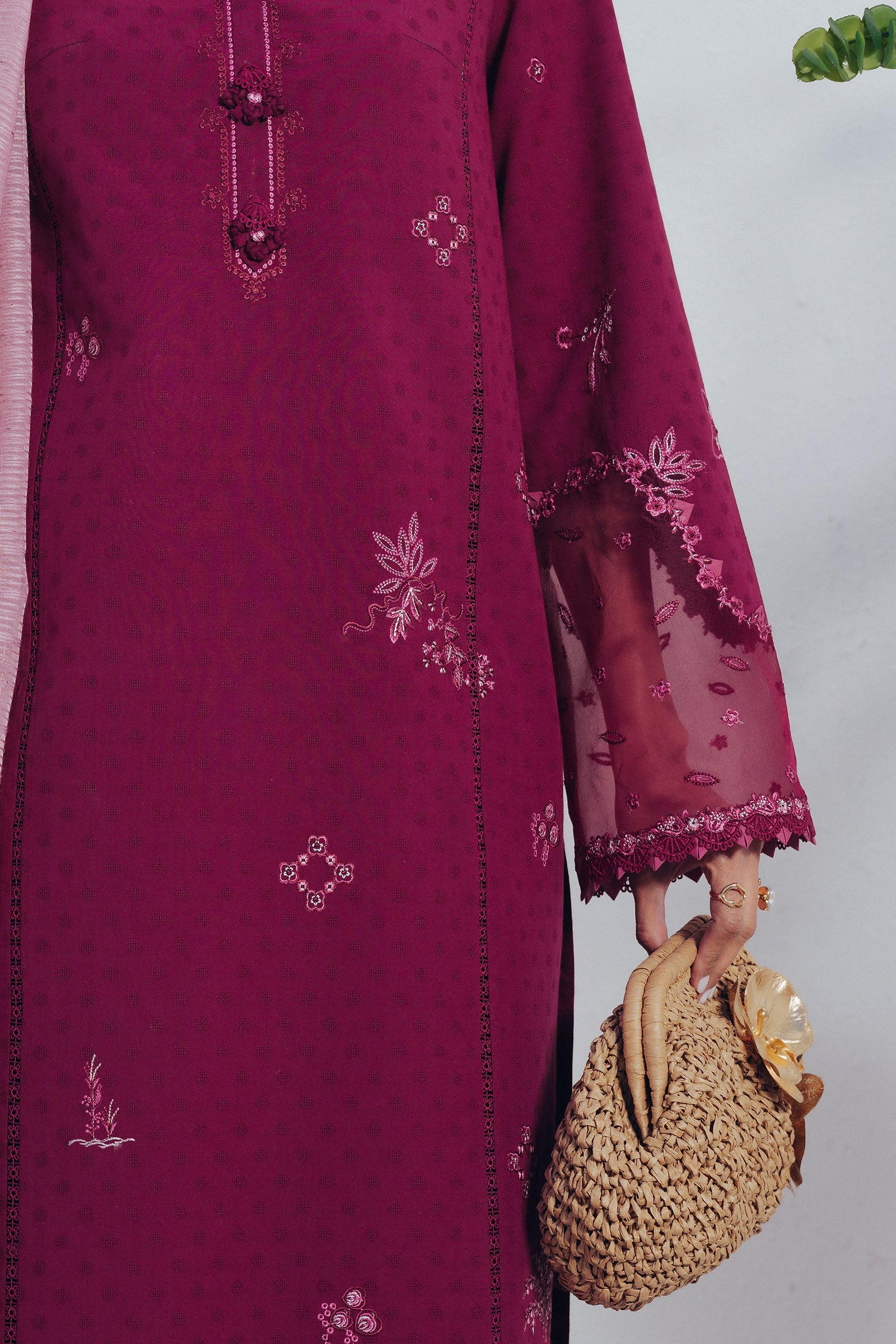 "Focus on the intricate sleeve cuff trimmings and lace hemline details of the Qalamkar QBP-04 LIVIA stitched luxury suit, showing boutique-quality tailoring."
