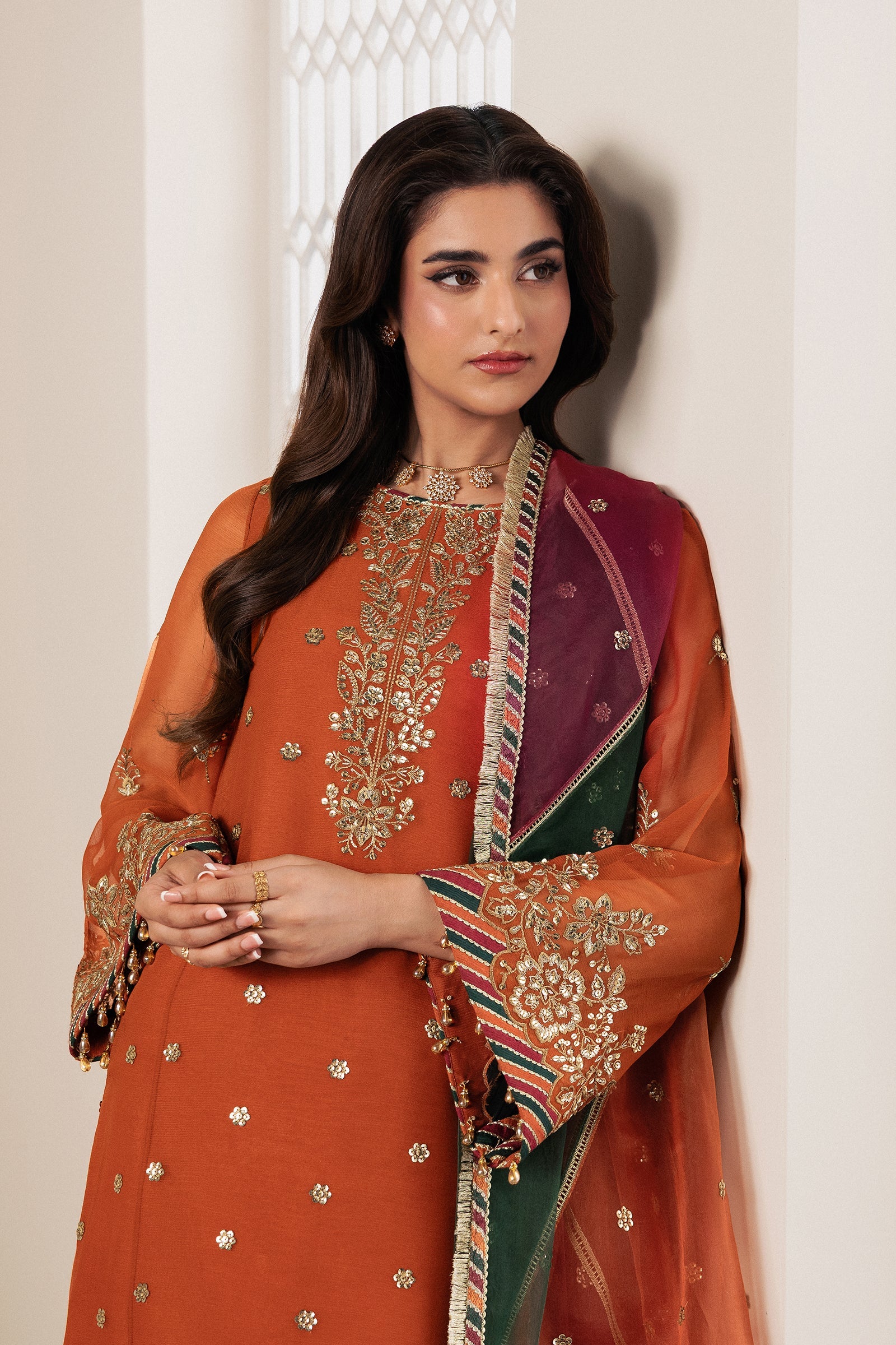"Focus on the wide flared embroidered raw silk sharara hemline and chattapatti border trims of the Zarif SUNOOR stitched suit."