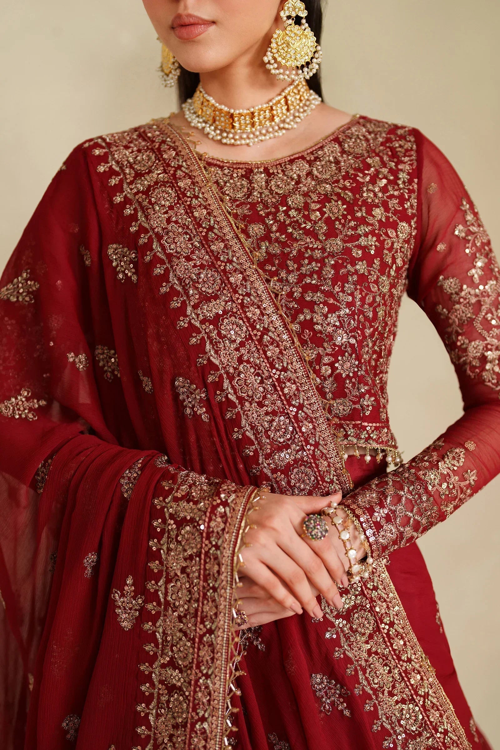 "Focus on the intricate sleeve cuff trimmings and hemline details of the Zarif Sumrah stitched formal suit, showing boutique-quality tailoring."