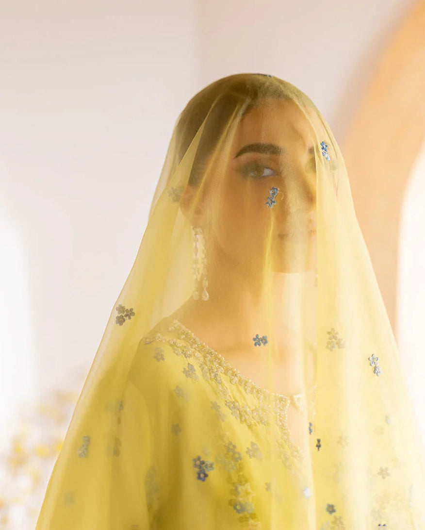 "Focus on the dupatta and lace hemline details of the Mushq Lumiere stitched luxury suit, showing boutique-quality tailoring."