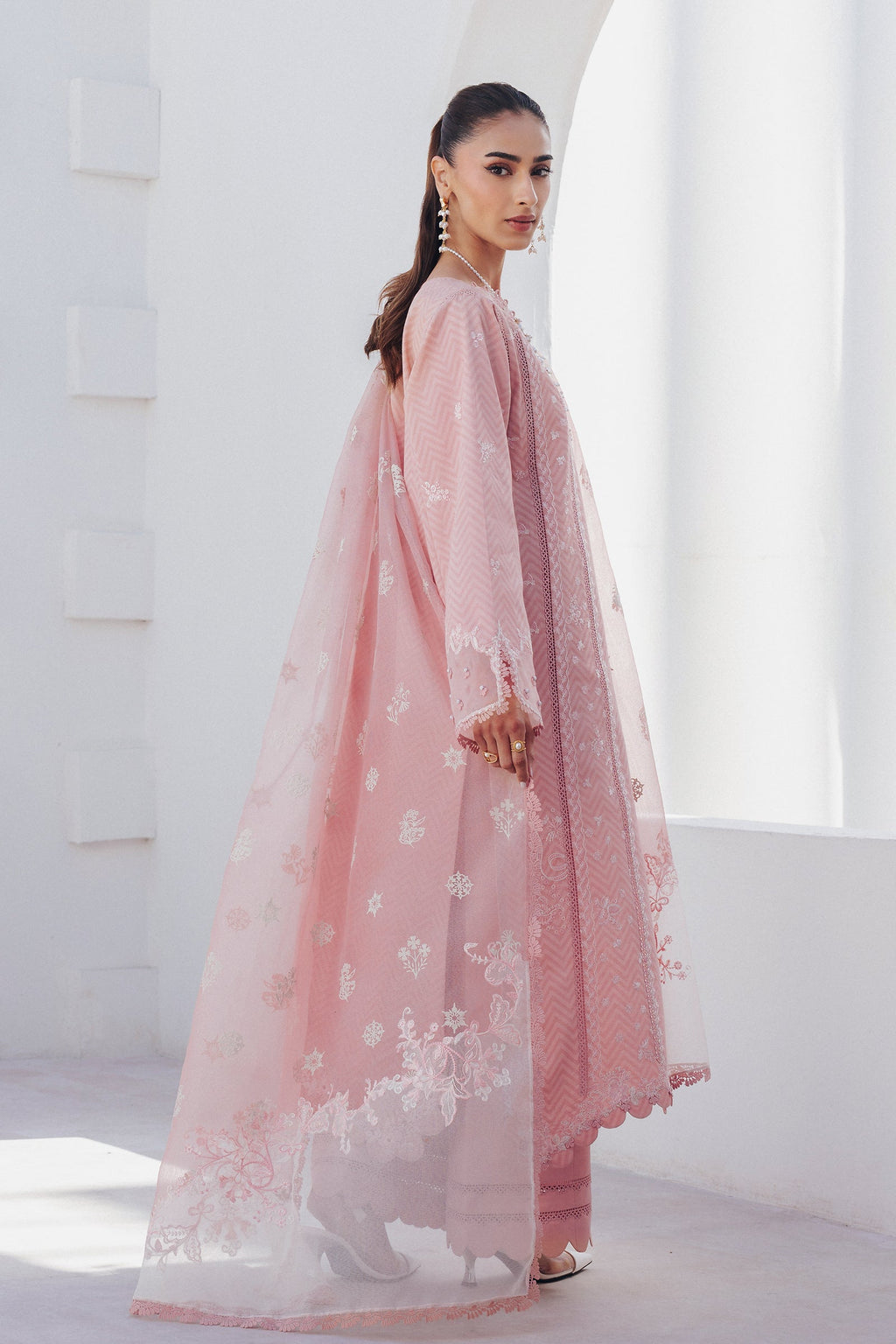 "Focus on the intricate sleeve cuff trimmings and lace hemline details of the Qalamkar QBP-03 GIANA stitched luxury suit, showing boutique-quality tailoring."
