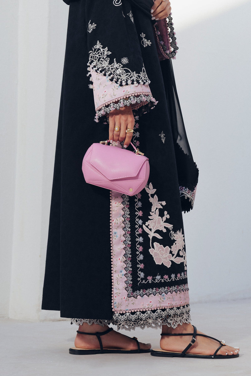 "Focus on the intricate sleeve cuff trimmings and lace hemline details of the Qalamkar QBP-07 DORTE stitched luxury suit, showing boutique-quality tailoring."