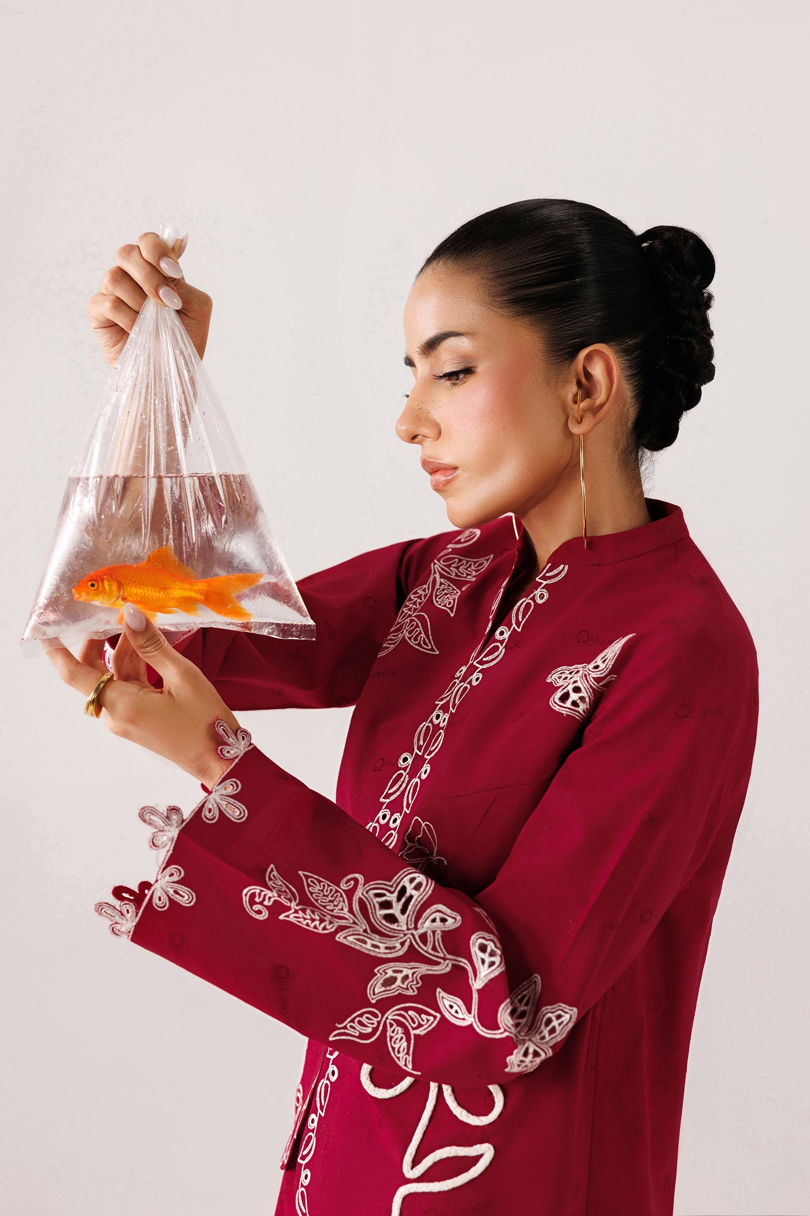 "Focus on the intricate sleeve cuff trimmings and lace hemline details of the Qalamkar QEC-10 Reina stitched luxury suit, showing boutique-quality tailoring."