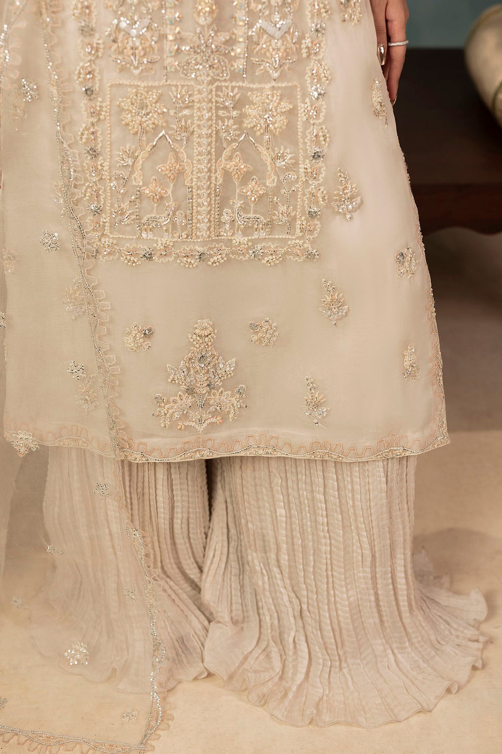 "Focus on sleeve cuffs and fluid crushed silk trouser detailing of Motifz 0073 Aila hand embellished organza suit, displaying boutique-level tailoring."