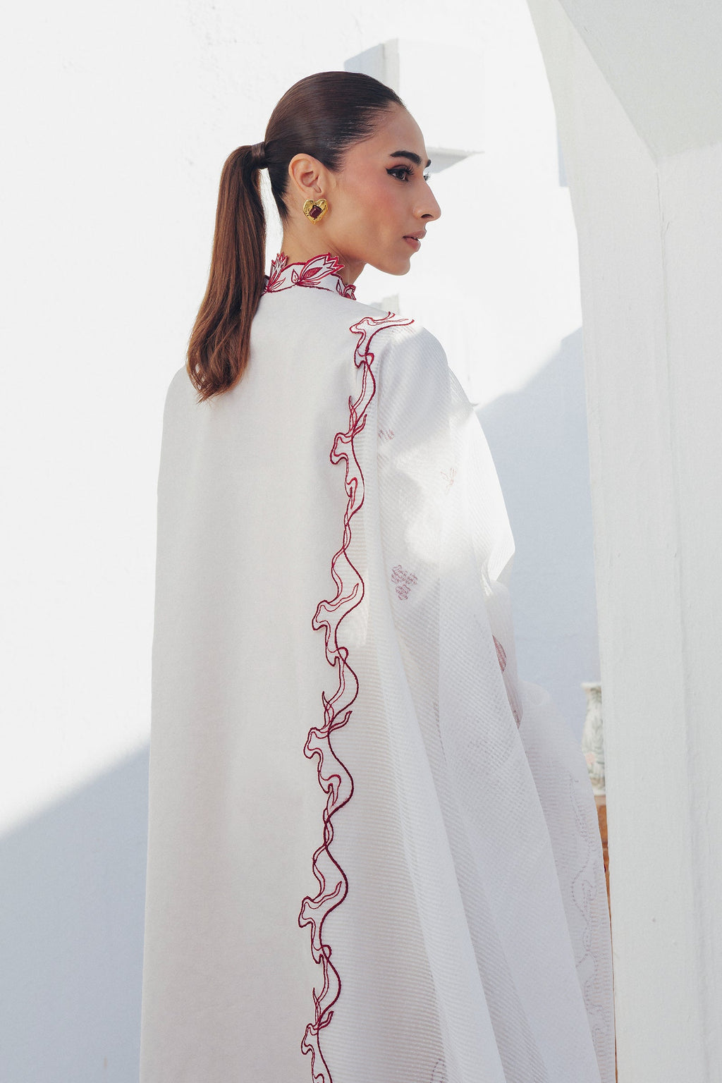 "Focus on the intricate sleeve cuff trimmings and lace hemline details of the Qalamkar QBP-01 ALBA stitched luxury suit, showing boutique-quality tailoring."