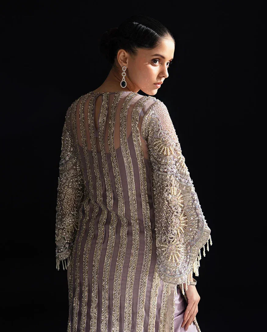 "Focus on the intricate sleeve cuff trimmings and lace hemline details of the Mushq Nuru stitched luxury suit, showing boutique-quality tailoring."